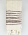 Folded brown colour with multiple stripes on a plain beige colour.