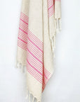 Pink colour with multiple stripes on a plain beige colour hanging.