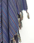 Close-up image of multi-colour scarf cotton in navy base colour with knotted fringe.