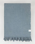 Folded strong cotton blanket with a simple pattern in grey colour.